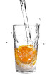 Photo: pouring water into glass with orange slice on white pouring water into glass with orange slice on white