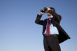 Photo: Businessman searching with his binoculars Businessman searching with his binoculars