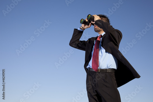 Photo: Businessman searching with his binoculars Businessman searching with his binoculars