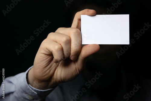 Photo: Man holding business card. Close up shot Man holding business card. Close up shot