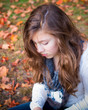 Photo: lonely teenage girl sitting quietly in fall leaves lonely teenage girl sitting quietly in fall leaves