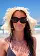 Sexy young female on beach with hat
