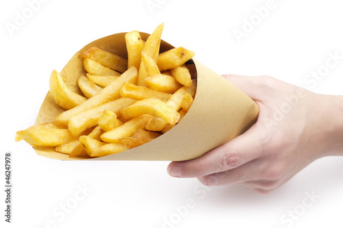 Photo: hand holding a funnel paper with fries hand holding a funnel paper with fries