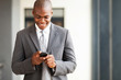 Photo: young african american businessman reading email on smart phone young african american businessman reading email on smart phone