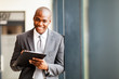 Photo: african american businessman writing report in office african american businessman writing report in office
