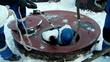 Worker in a gas mask goes down to the dungeon through the hatch