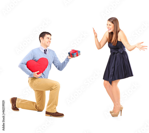 Photo: Smiling male giving flowers and excited female Smiling male giving flowers and excited female