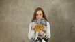 Young woman in scarf throws up leaves