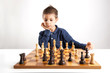 Child playing chess, isolated on white background.