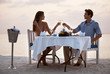 Attractive couple enjoying dinner at the beach