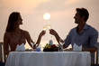 Romantic moments - Couple at beach sunset enjoying dinner