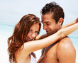 Beautiful young couple in love at the beach