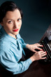 Young woman typing with old typewriter