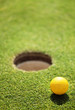 golf ball on lip of cup