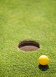 golf ball on lip of cup