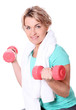 Cute mid aged women with towel do exercises with dumbbells