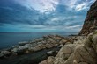 Gloomy sky over rocky shore