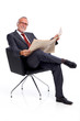 Sitting mature business man with newspaper