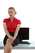 Flirtatious secretary sitting on the table