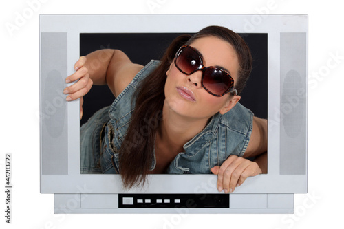 Photo: Woman coming out of a television screen Woman coming out of a television screen