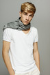 Photo: Young handsome male in scarf posing with hands in pockets Young handsome male in scarf posing with hands in pockets