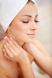 Photo: Sweet young woman with hands on her neck Sweet young woman with hands on her neck