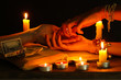 reading the lines hand in a woman's hands on black backcground