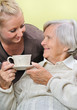 Senior woman with caregiver at home.