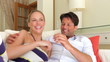 Couple Relaxing On Sofa Together