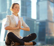 Business woman meditating outdoor