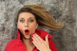 Woman in surprise lying on a carpet