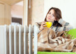 woman near oil heater at home