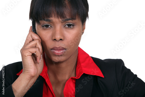 Photo: Stern businesswoman making call Stern businesswoman making call