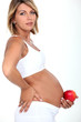 Pregnant woman with an apple
