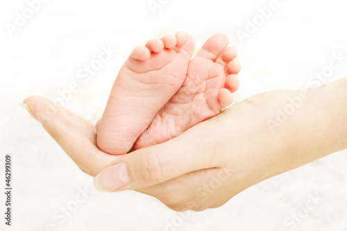 Photo: Baby legs in mother hands Baby legs in mother hands