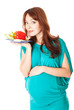 a pregnant woman with a plate of vegetables
