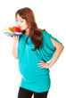 a pregnant woman with a plate of vegetables