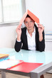 Young woman hiding under a file