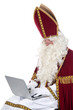 Photo: Sinterklaas using a laptop Sinterklaas using a laptop