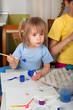 Photo: Two little girls (sisters) painting on Easter eggs Two little girls (sisters) painting on Easter eggs