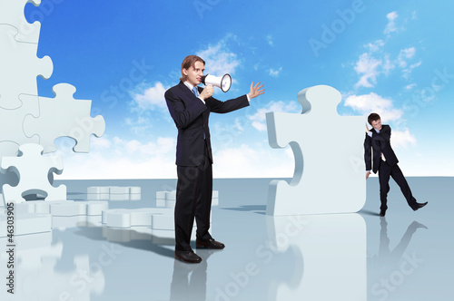 Photo: Businessman with a puzzle pieces Businessman with a puzzle pieces