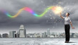 Businessman with colourful light beam in his hands