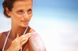 Lovely woman applying lotion