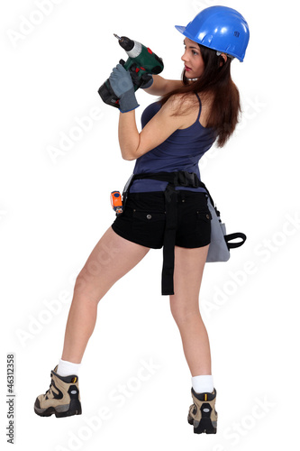 Photo: sexy craftswoman holding a drill sexy craftswoman holding a drill