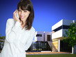 Woman on the phone by beautiful villa