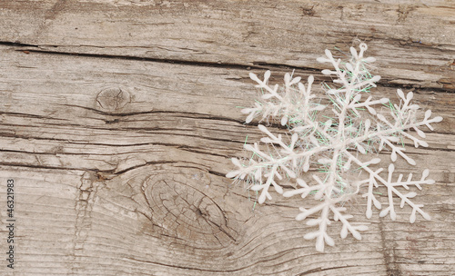 Photo: Christmas decorations (snowflake) on wooden background Christmas decorations (snowflake) on wooden background