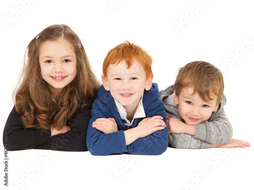 Photo: Happy smiling children laying in group Happy smiling children laying in group
