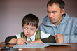 Photo: Father helping son doing homework Father helping son doing homework