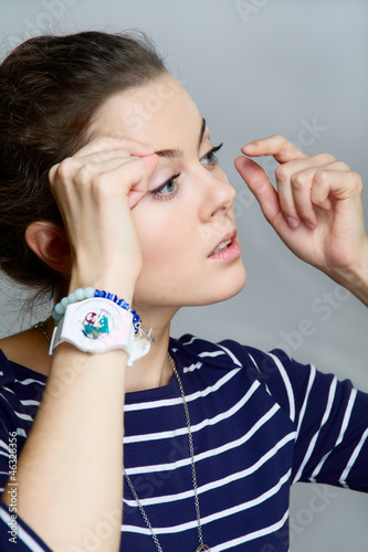 Photo: girl corrects make-up girl corrects make-up