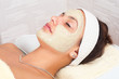 Beautiful young woman with natural facial mask